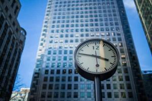 Image of a large clock in a city.