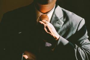 Photo of a man in a suit preparing for a career move.