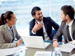 Photo of project managers discussing at a table.